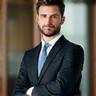 Portrait of a confident businessman in a tailored suit, looking professional.